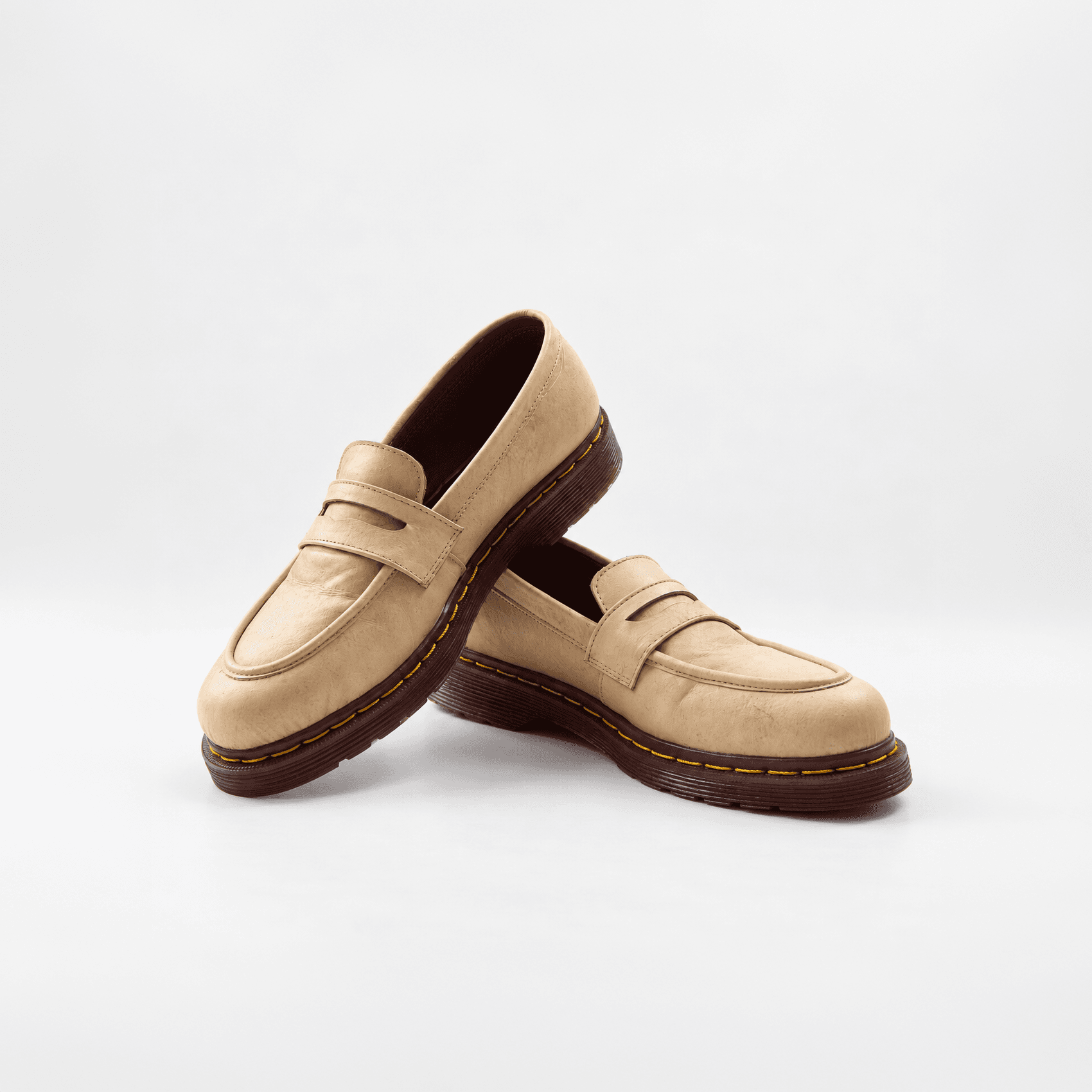 Pair of tan mycelium penny loafers with dark brown soles